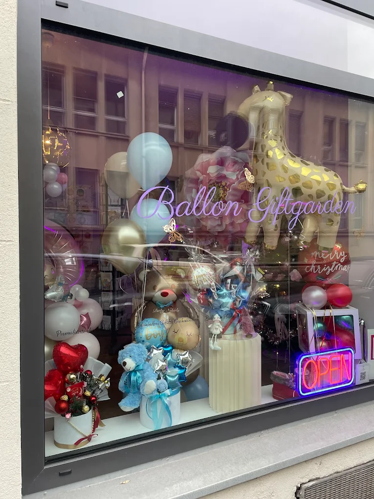 Schaufenster des Ladens Ballon-Giftgarden mit Schriftzug und Dekoration